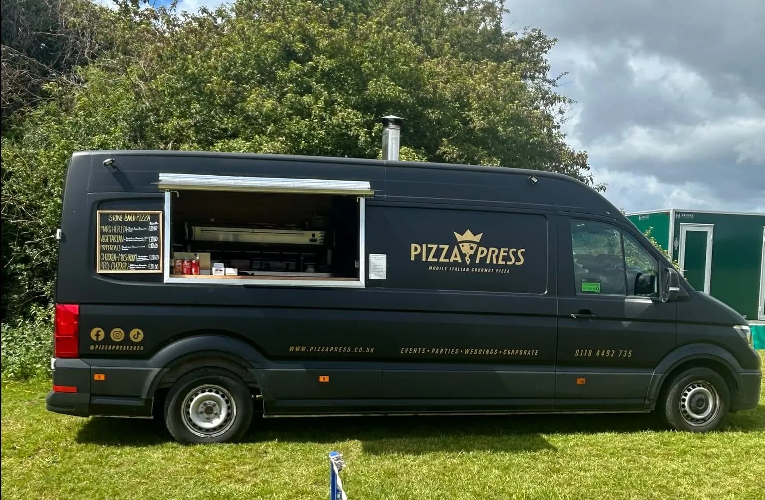 The Pizza Press mobile pizzeria set up with its serving hatch open