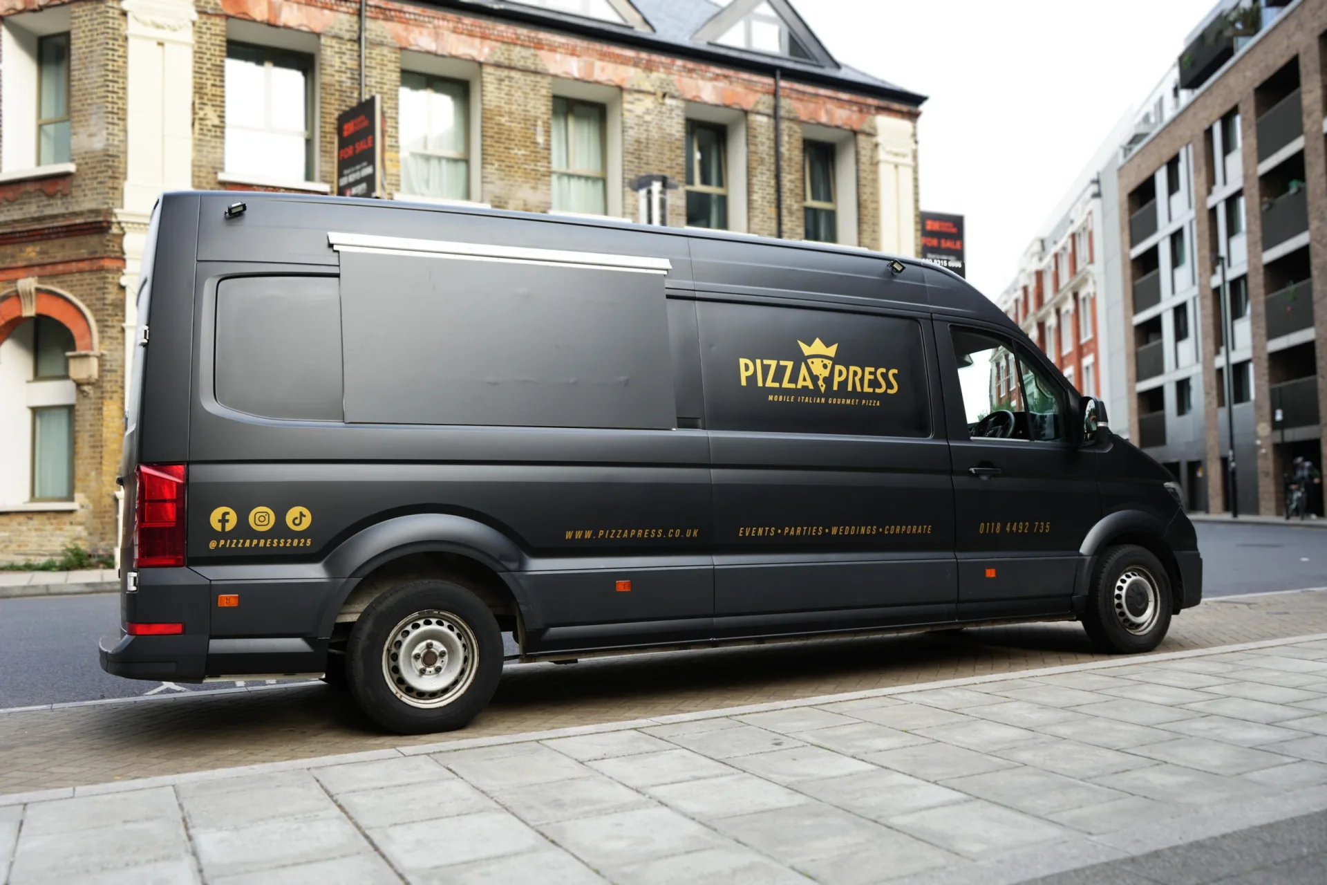 The matte-black Pizza Press mobile pizzeria